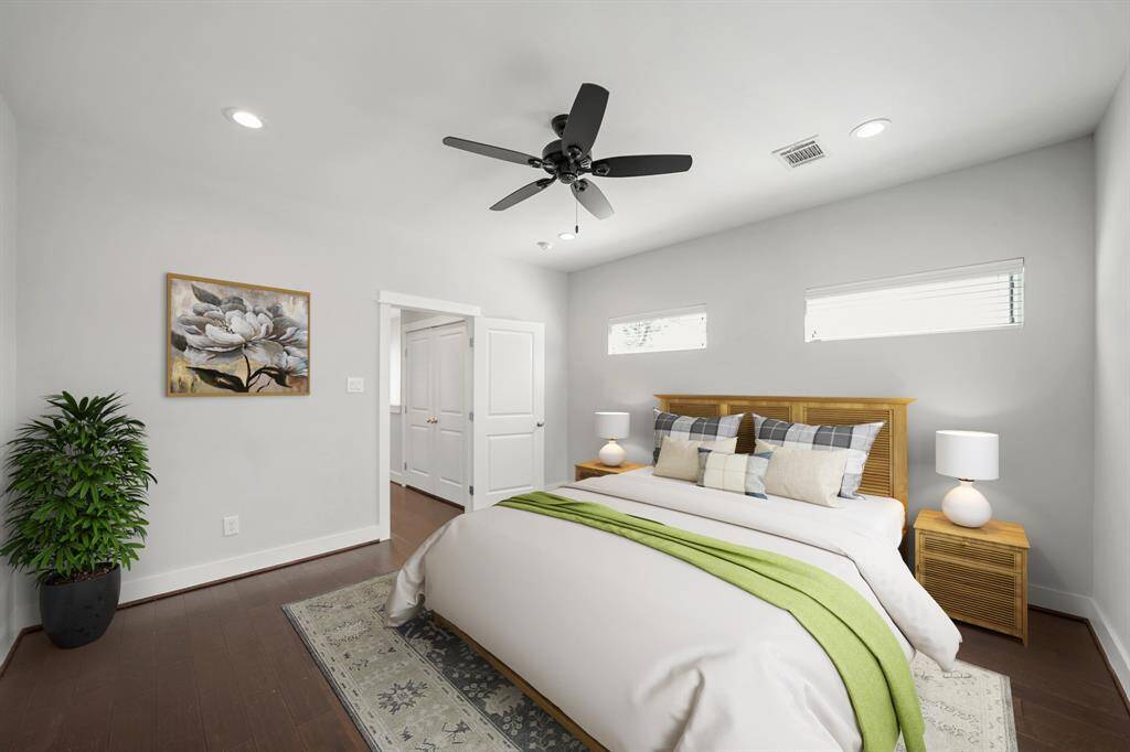 Upper windows with blinds offer privacy while adding natural light to this owner's bedroom. (This photo has been virtually staged.