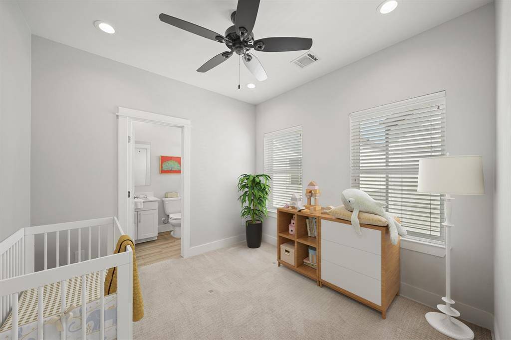 The secondary bedroom with an ensuite bath includes recessed lighting, a ceiling fan with lighting, two windows with blinds & patterned carpet. This photo has been virtually staged.