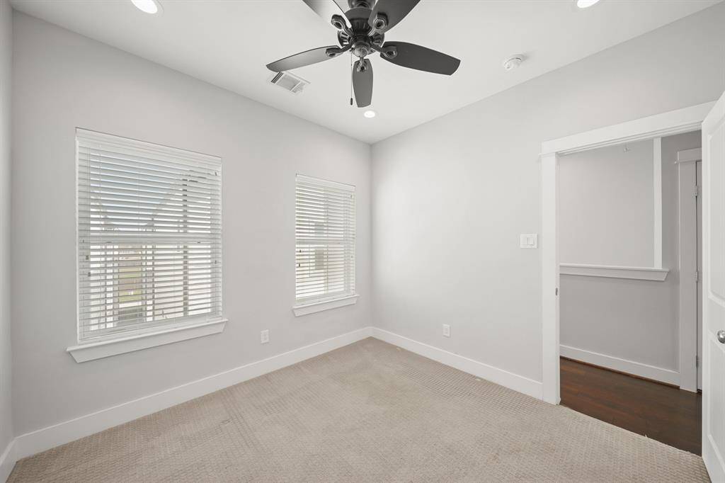 The second bedroom with the third floor corridor in the background.