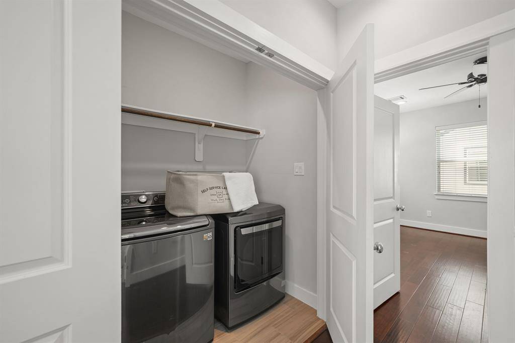 Tucked away behind a double door entry, the utility room has upper shelf & hanging wardrobe storage along with an LG full size washer & dryer & tile flooring.