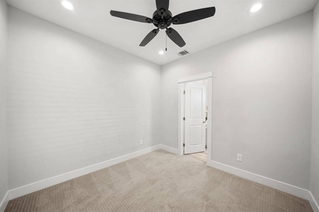 Features include recessed lighting, a ceiling fan, window with blinds & patterned carpet.