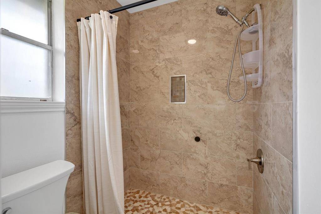 Large tiled shower in the secondary bath