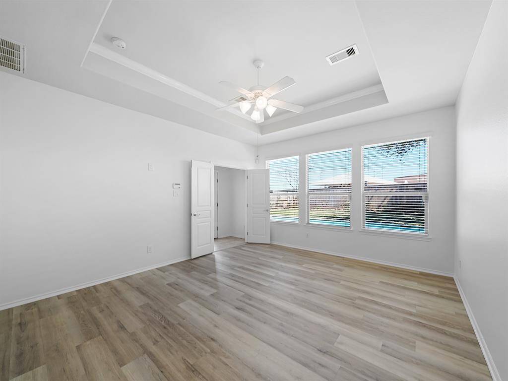 Escape to the luxurious primary suite, your personal haven designed for ultimate relaxation and rejuvenation. The tray ceiling adds an elegant touch, while the large windows flood the space with natural light.