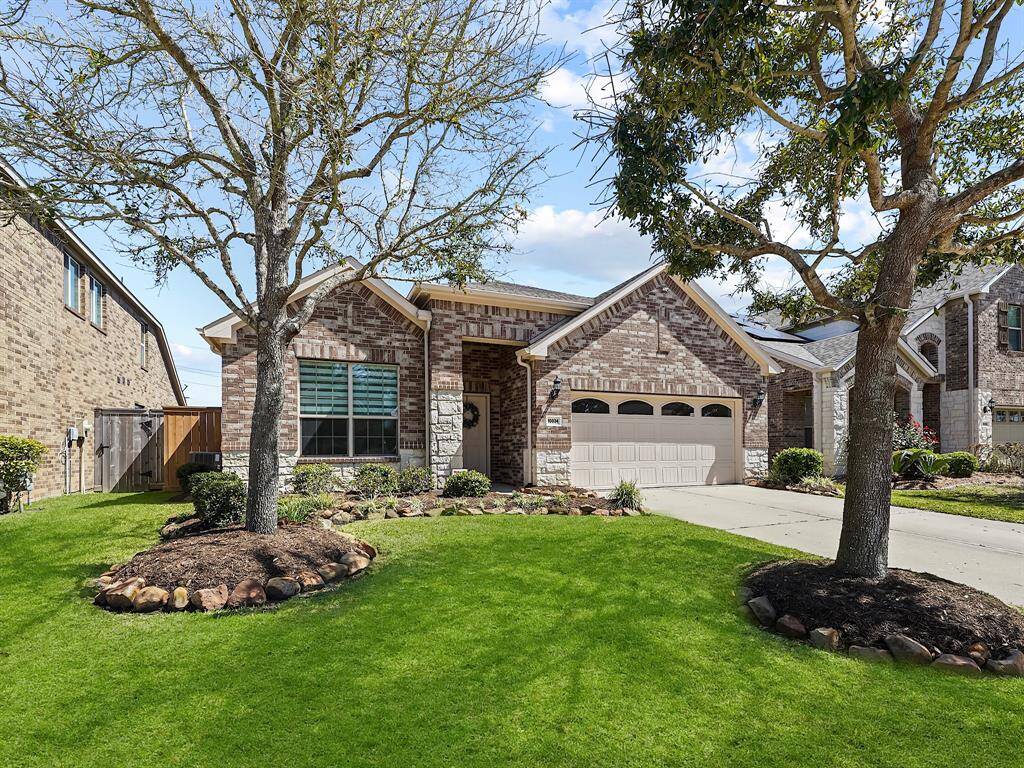 Boasting exceptional curb appeal with a sophisticated brick and stone elevation, beautifully complemented by meticulously maintained landscaping, this home is sure to impress from the moment you arrive