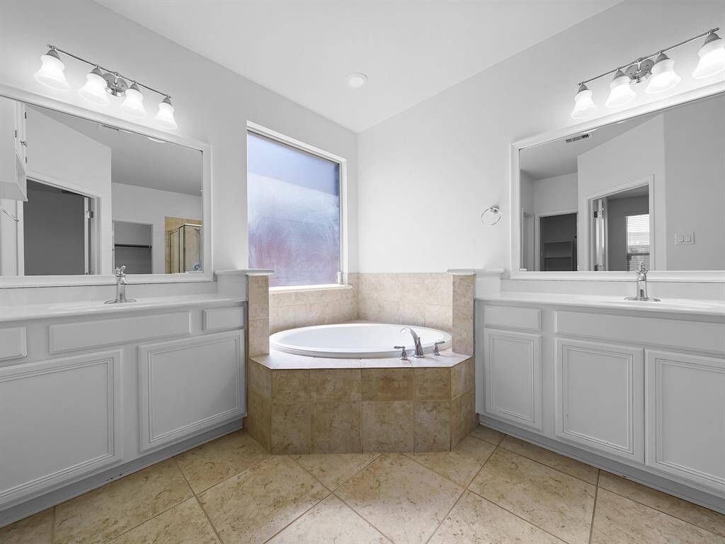 Indulge in the spa-like ensuite bathroom, complete with elegant fixtures and ample space to unwind after a long day.