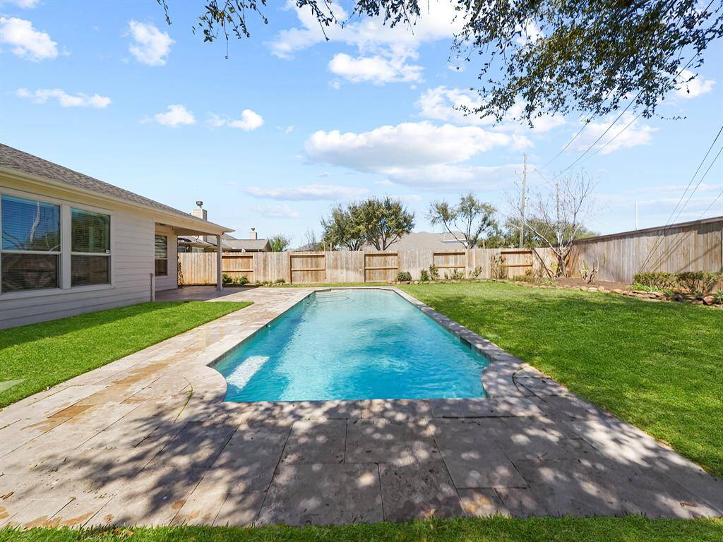 The sparkling pool beckons on hot summer days, providing a refreshing escape from the heat and endless hours of fun for family and friends.