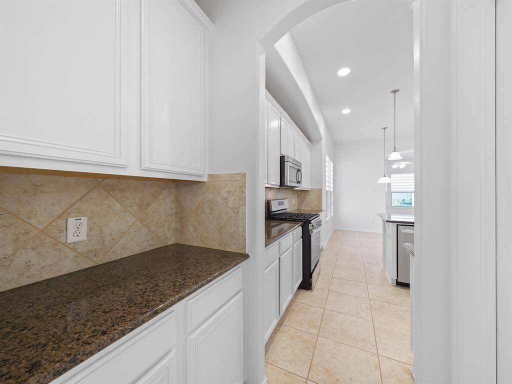 his home boasts a convenient butler's pantry with direct access to a generously sized walk-in pantry, offering ample storage and functionality.