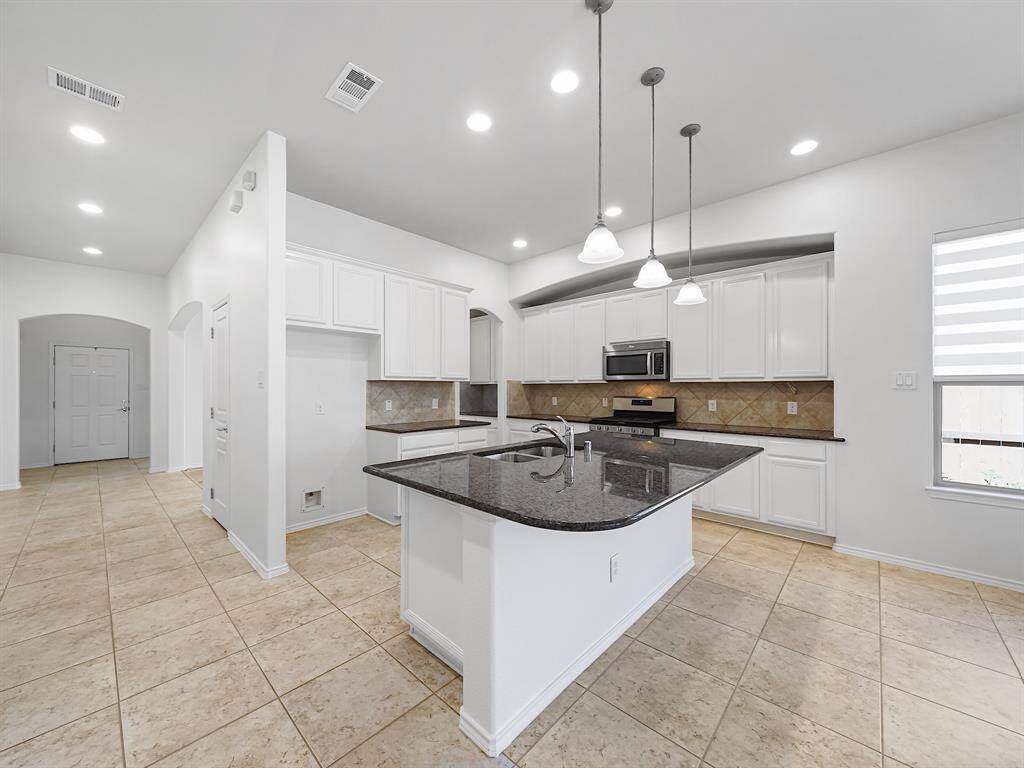 The huge island kitchen is a culinary enthusiast's dream, featuring exquisite granite countertops, gleaming stainless steel appliances, and an abundance of cabinet and counter space!