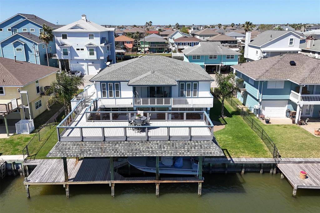 The large boathouse upper deck provides a covered sitting area on the pier below.