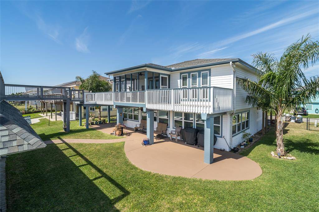 This home is fully fenced on three sides with black chain-link fencing.
