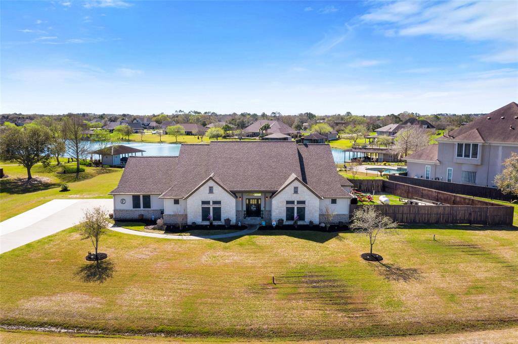 Welcome to this beautiful custom estate with a large front yard and a scenic backyard lake view.