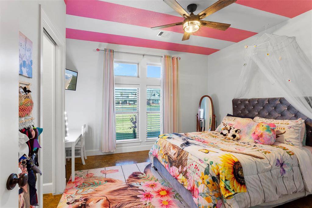 Bedroom #2 features large picture windows allowing plenty of natural light into the room. There's a cozy corner nook, perfect for a desk or vanity area.  Through the door, enjoy the private sink and walk-in closet.