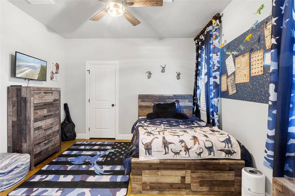 Bedroom #3 has ample natural light through the picture windows, a walk-in closet with storage and a private sink and vanity area.
