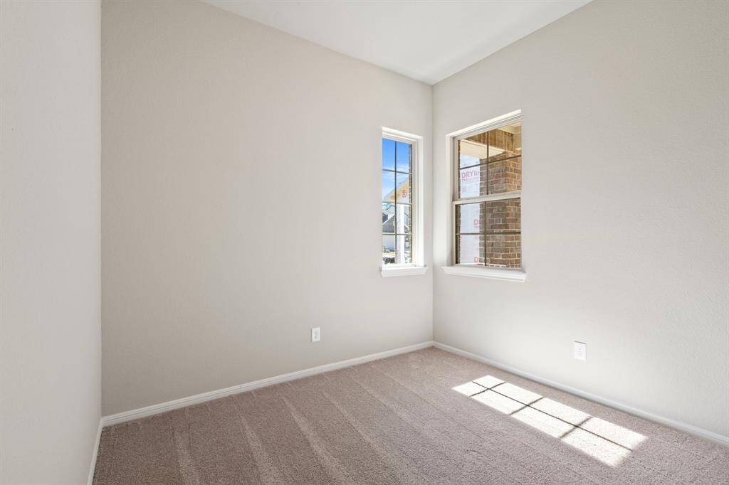 Your secondary bedroom features plush carpet, fresh paint, closet, and a large window that lets in plenty of natural lighting.