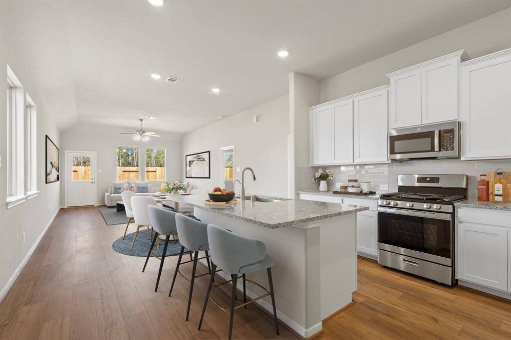 This home boasts a spacious open concept layout that combines the best of modern design and comfort for everyday living. Photo is virtually staged