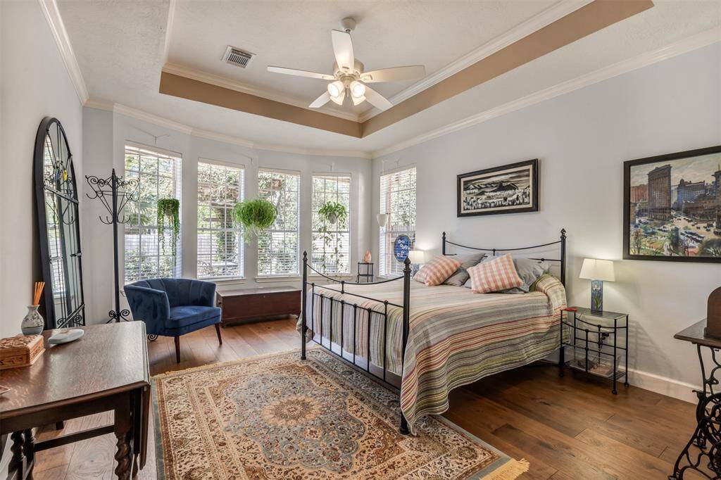The primary bedrooms is located on the first floor. The hickory floors are continued into this large space. This room can accommodate a king size bed and sitting area over looking the resort style backyard. This bedroom is ensuite.
