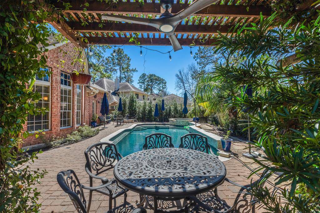 Another great location to eat a meal or take a break from the sun. This wood pergola has accent lights, a ceiling fan with light, and vines growing up the sides.