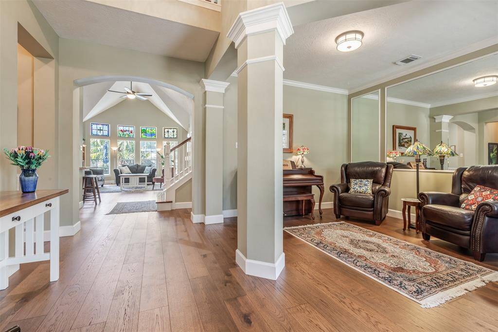 Welcome home. This view shows the interior while standing in the foyer. Beautiful engineered hickory floors are throughout the first floor. The room to the right is currently being used as a music/reading room but could be used a dining room.