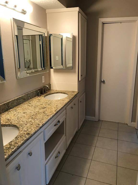 Tub/shower are separate from the vanity area behind the door at the back of the photo