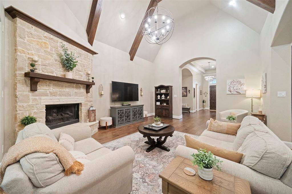 Gorgeous expanded stone fireplace with hearth and gas logs.