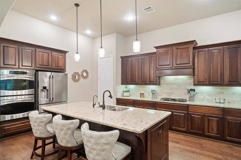 Kitchen comes with double SS self cleaning ovens, SS refrigerator and a massive amount of workspace and cabinets.