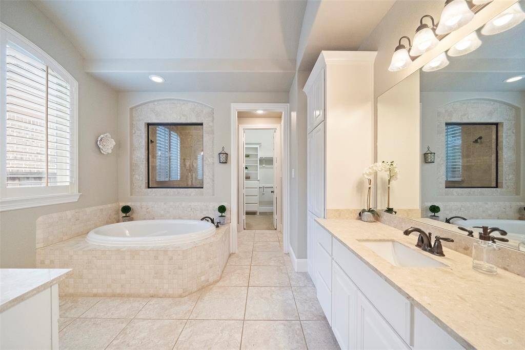 Spa retreat features 2 separate vanities, oversized walkin shower, large soaking tub & a huge closet with builtin storage.