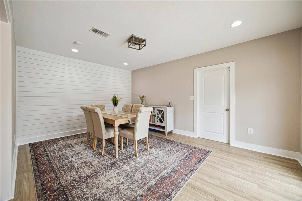 Another view of the dining room.  Door is access to the two car garage.  The room also has double doors out to the backyard.