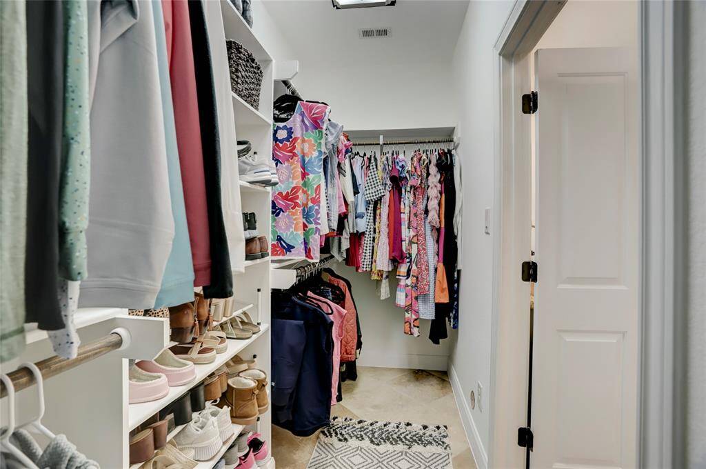 The primary closet offers plenty of hanging space as well as built in shoe/hand bag storage.