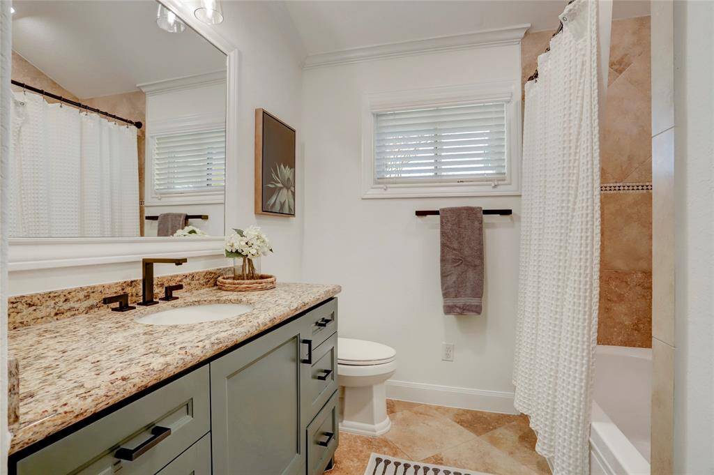 The third full bathroom sits in the hallway with access for guests and the third bedroom.