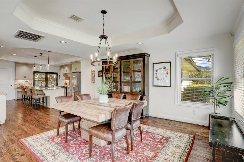 As you walk in the front door, the home opens up to dining room, living, and kitchen.
