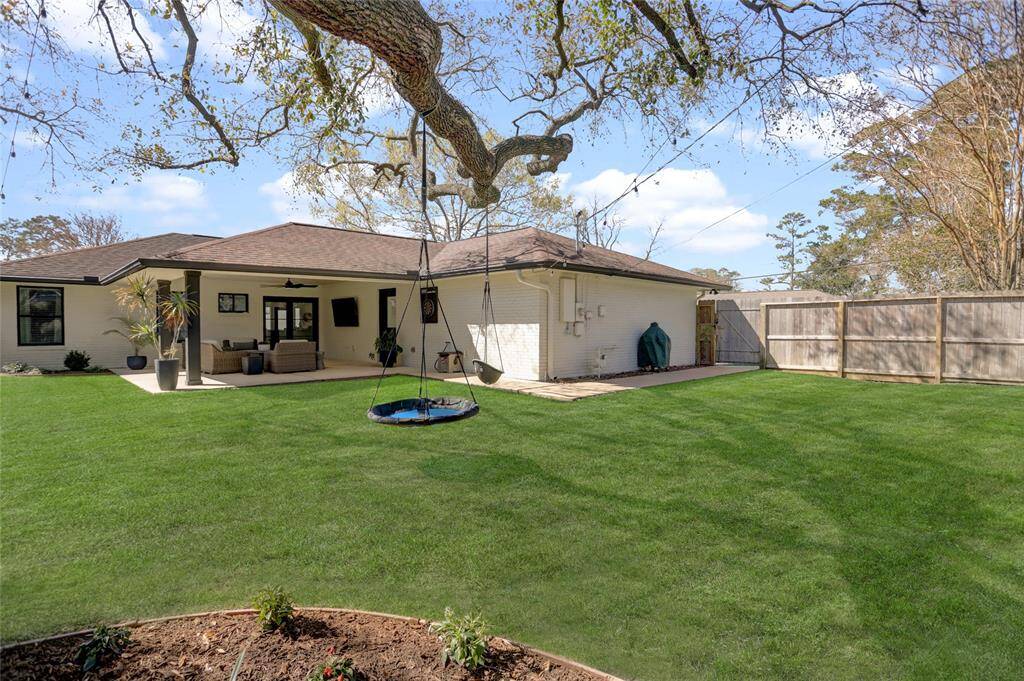 View of the backyard from the Northeast corner of the property, showing the "L-shaped" yard.