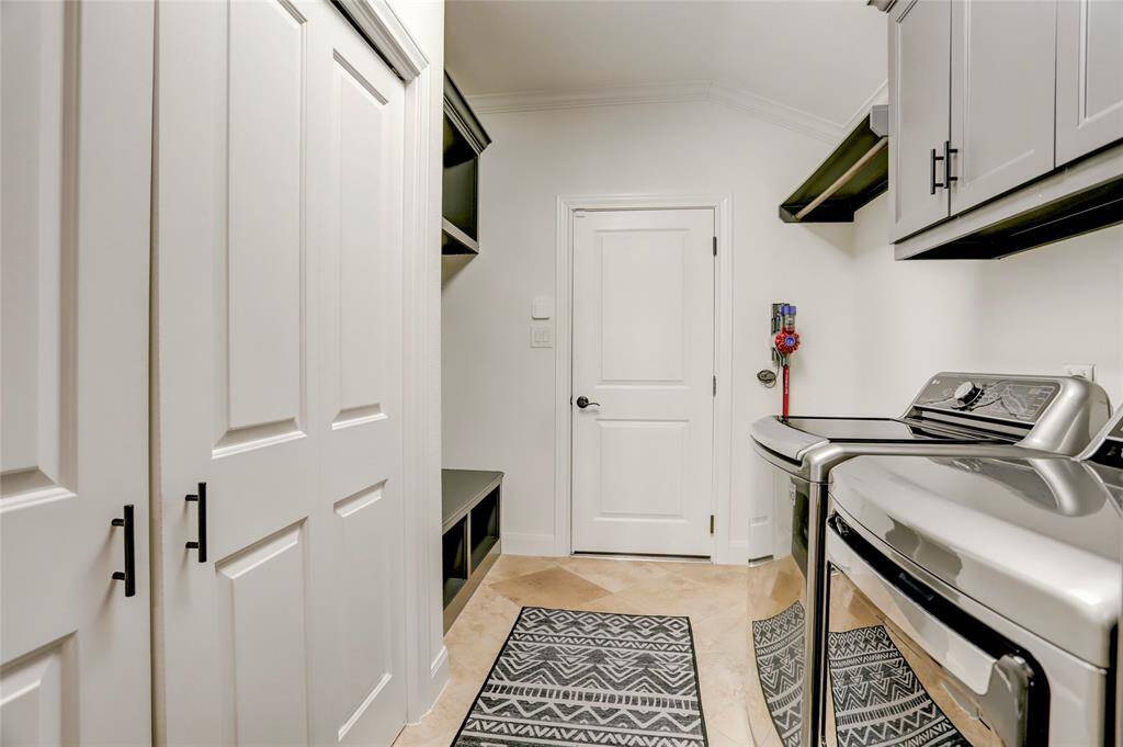 Sitting between the garage and kitchen is an organized mud room/utility with a closet pantry, built-in storage and space for washer/dryer and additional fridge/freezer.