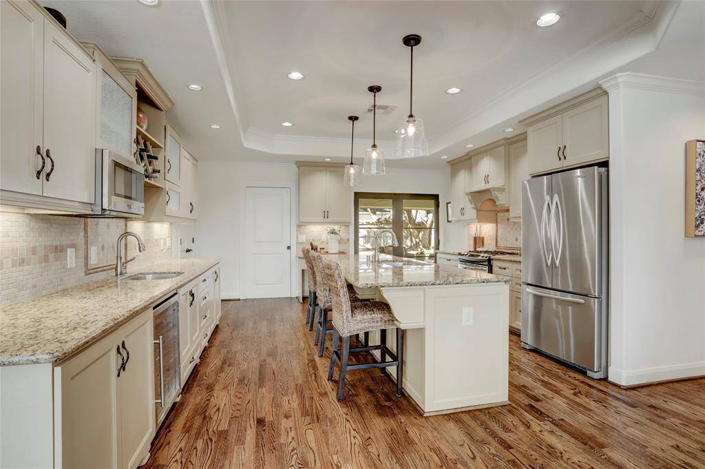 Open to the dining and living rooms, the island kitchen is sure to impress. With an incredible amount of counter and cabinet space, it's perfect for entertaining large groups gathering in the kitchen.
