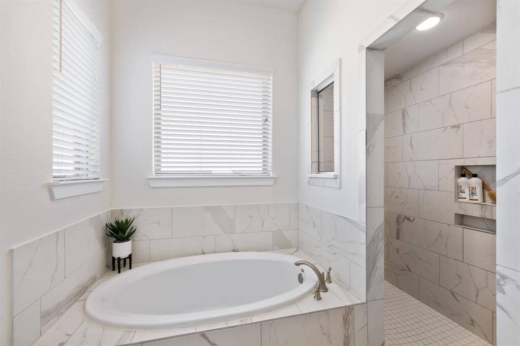 Large walk n shower with large format marble tile and matching square mossaics.