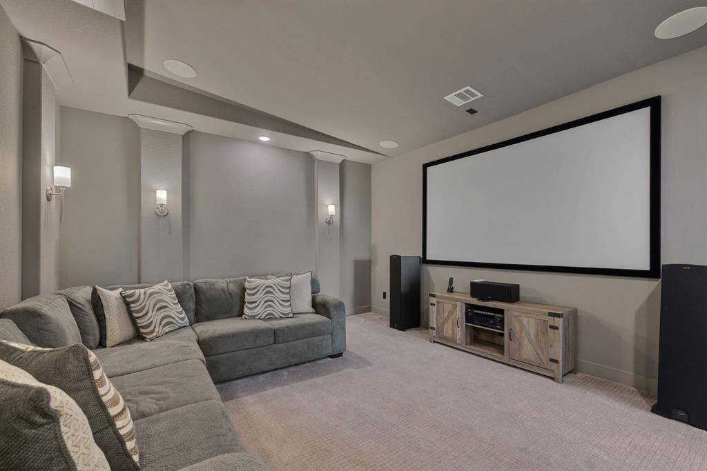 Nicely appointed media room includes screen and projector. Media room includes projector, screen and speakers if buyer is interested.