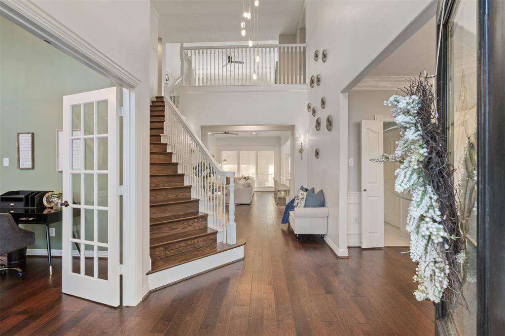 Walk into the grand formal entry with soaring ceilings and updated lighting, flooring, painting and more