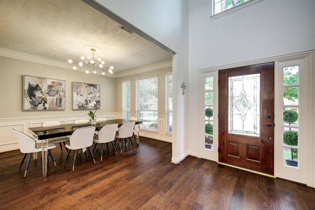 The formal dining area has modern lighting, large windows, and exudes elegance and sophistication. Imagine hosting your next holiday meal or family gathering with room for a large dining table and chairs.  This dining room makes a great first impression as you enter this home.