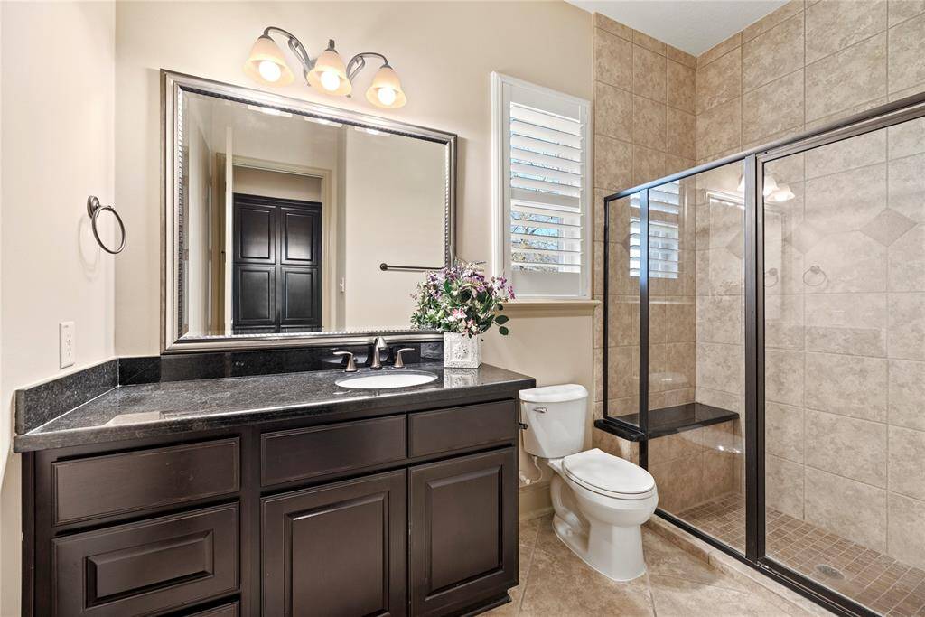 The dedicated private bath for your 2nd bedroom, with a large glass enclosed shower.
