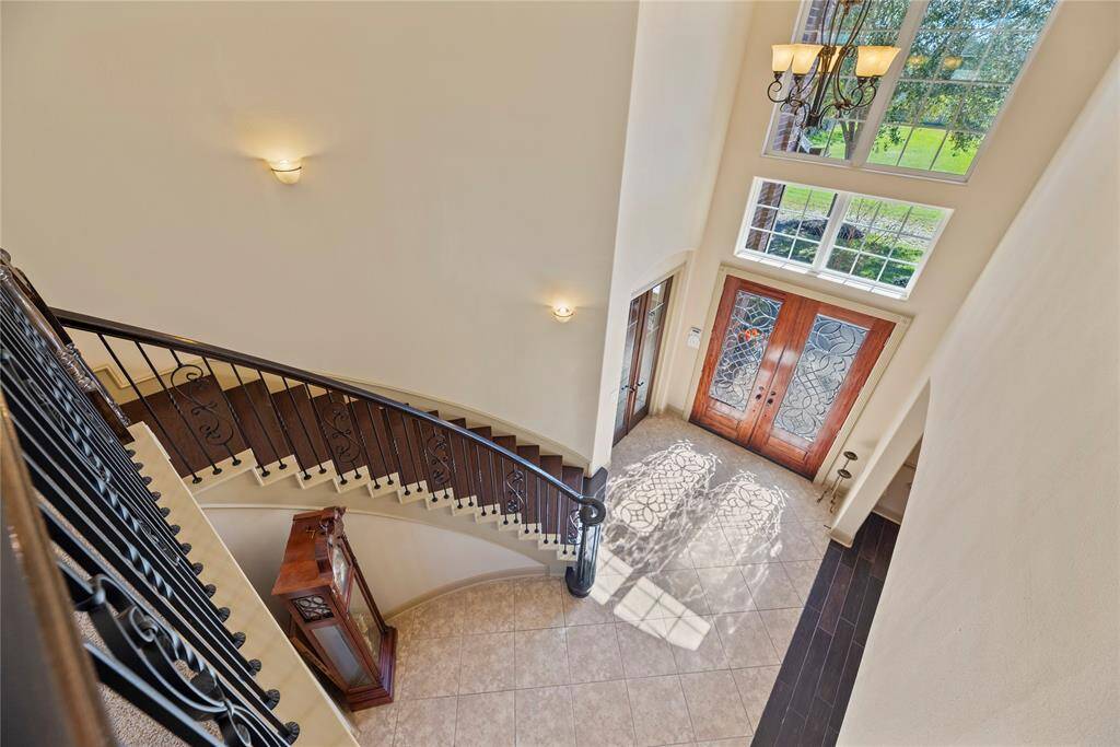 Even the staircase exudes elegance, featuring a harmonious blend of neutral hues and exquisitely crafted designer iron spindles.