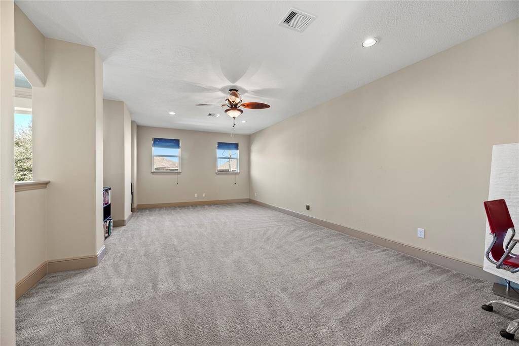 The whole family will love the expansive game room overlooking your living space below.