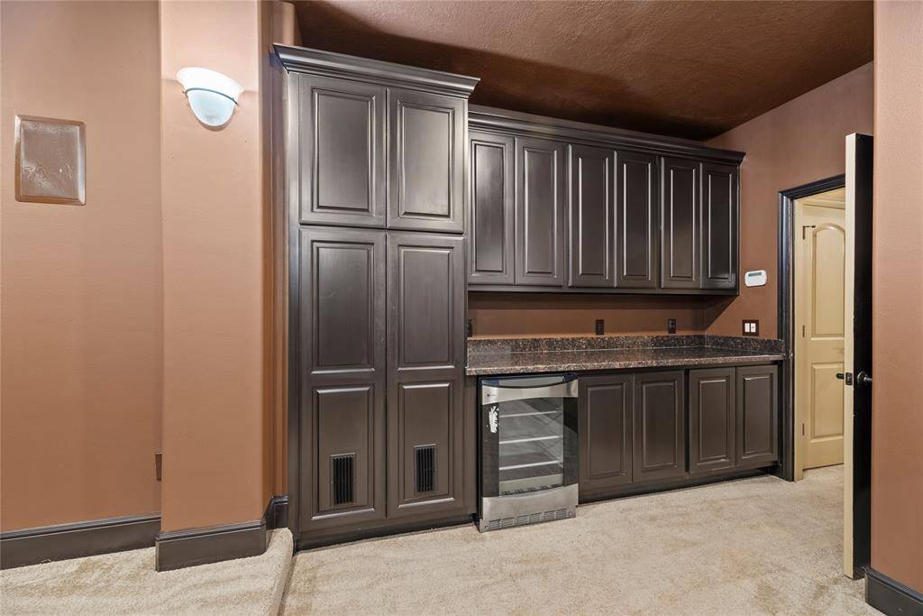 This exquisite built-in with beverage fridge is perfect for entertaining, seamlessly blending style and functionality.
