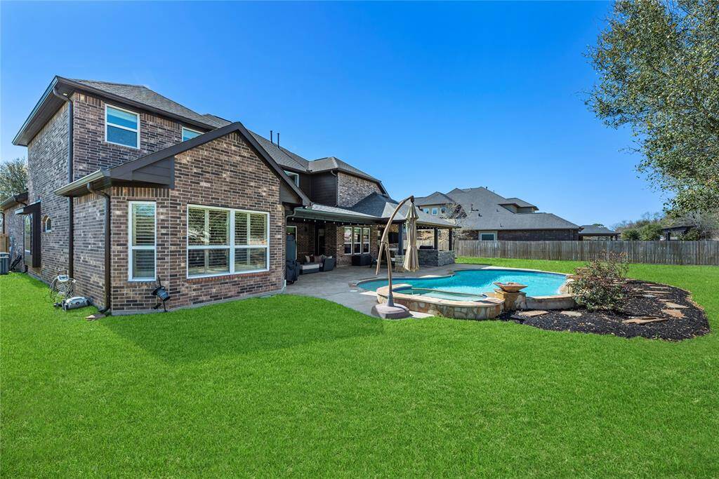 Bask in the warmth of the sun by day and savor peaceful evenings in this expansive backyard oasis, a perfect retreat for relaxation and unwinding in comfort.