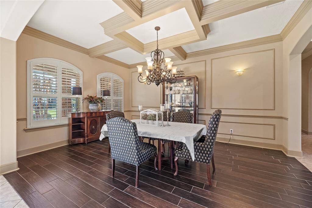 This spacious dining room is perfect for entertaining and will accommodate a large table, hutch, buffet or china cabinet. The combination of beautiful ceiling lines and gorgeous tile flooring sets a stunning backdrop for the formal dining space, adding warmth, texture, and architectural interest.