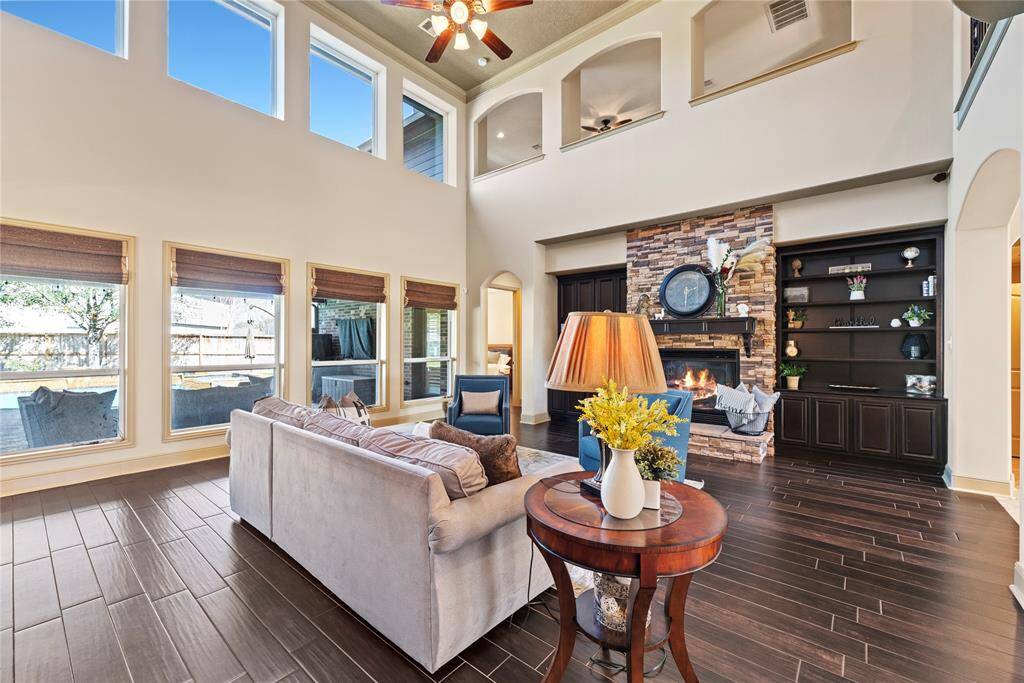 High ceilings can draw the eye upward, adding a sense of grandeur and elegance to the room. Sun-drenched living space with dramatic two-story ceilings.