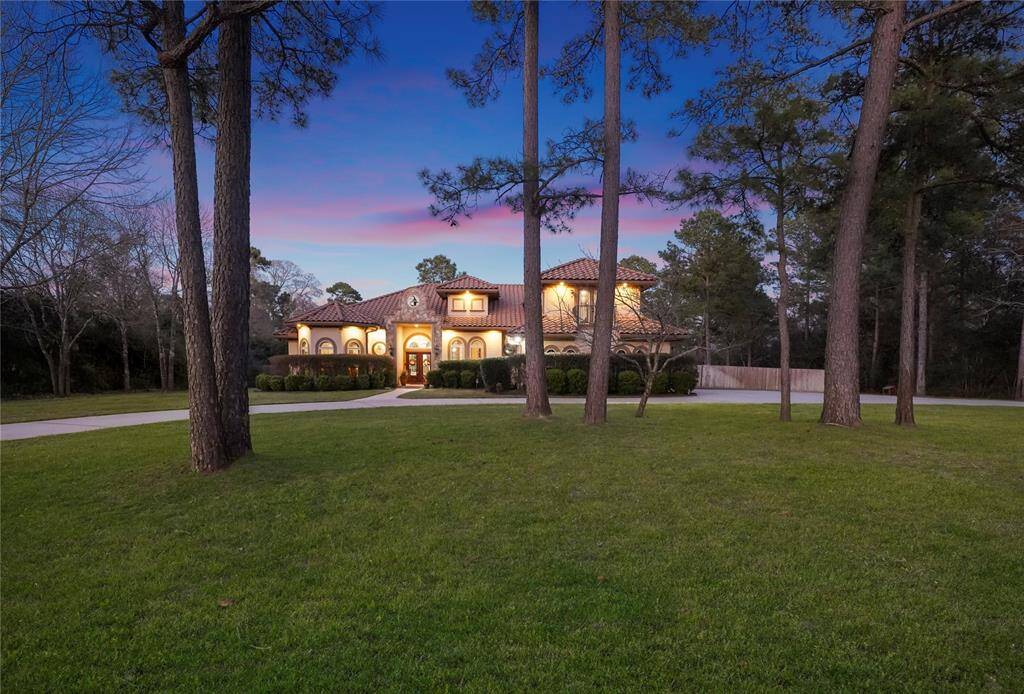 The gorgeous home, with many towering, mature trees all around, sits far away from the road. The row of trees in front provide shade and privacy.