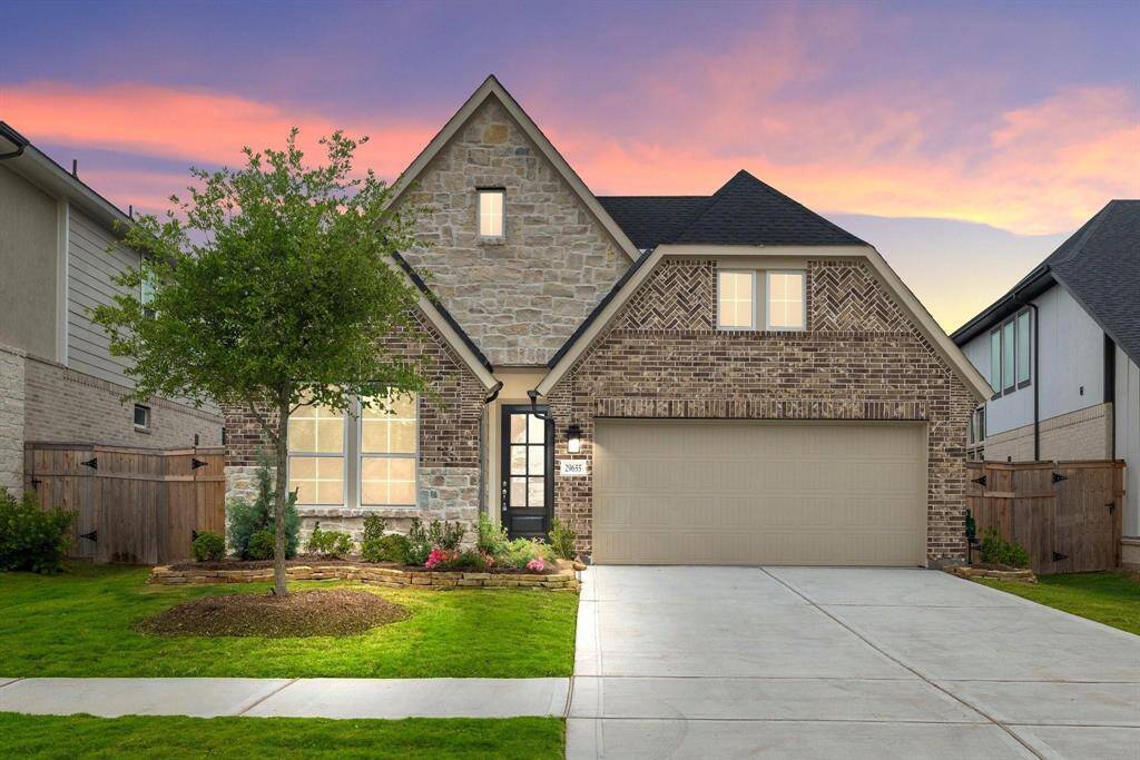 Stunning stone and brick exterior with impressive curb appeal with beautiful landscaping