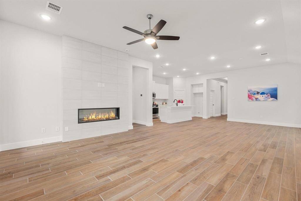 A spacious living room featuring a cozy fireplace.
