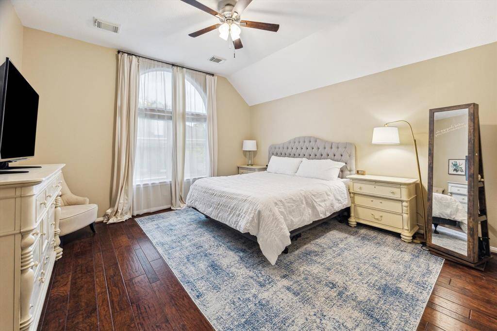 The beautiful downstairs primary bedoom with a large window overlooking the backyard has room for all of your furniture.