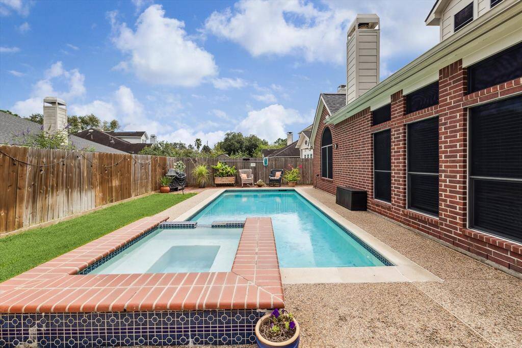 A wonderful heated pool with a hot tub and greenspace and a beautiful 4 bedroom home with 3 baths, all bedrooms downstairs and a 2nd floor bonus room,  zoned to Pearland ISD (buyer to verify).  New pool pump(2022) and new pool housing and cartridges(2024).  Note the solar screens on most windows on this all brick home.