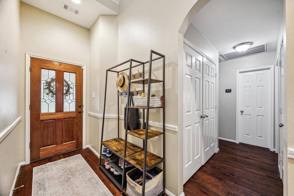To the left of the entryway are 3 downstairs secondary bedrooms and a bath.  Notice the beautiful engineered wood floors,